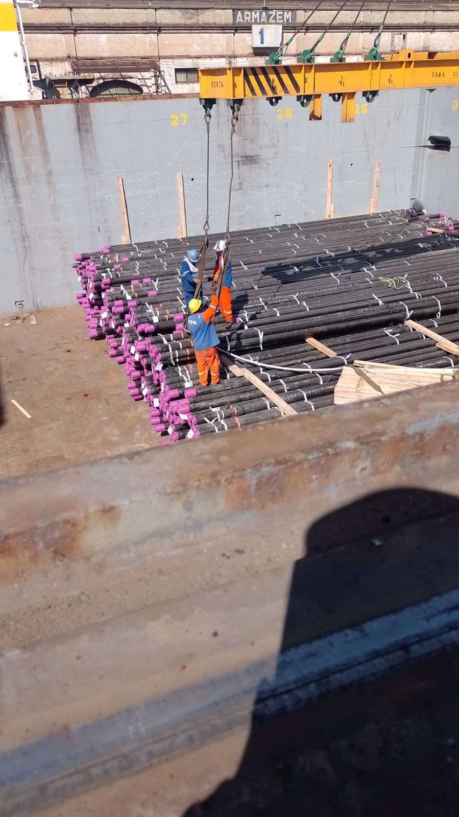 Vision Log team handling break-bulk cargo in a ship's hold
